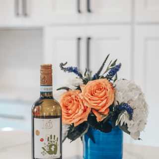 KRIS Pinot Grigio next to a floral arrangement by @SimplySheppard
